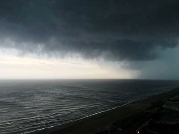 Scenic view of sea against storm clouds