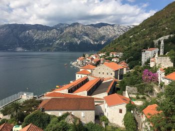 Houses by mountains against sky