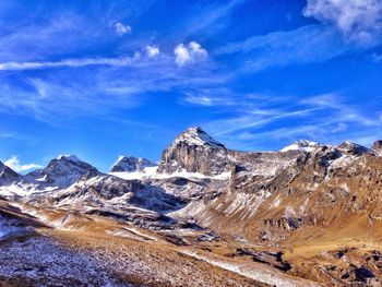 Scenic view of mountains against cloudy sky