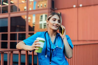 Portrait of young woman talking on phone