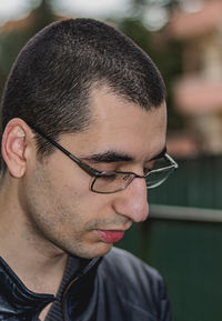 Close-up portrait of young man looking away