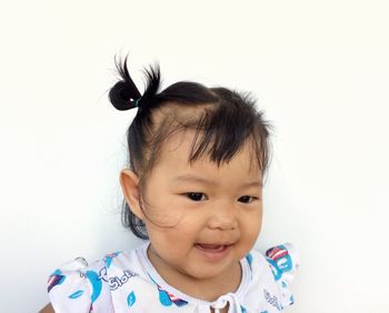 Portrait of smiling boy against white background