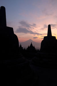 Silhouette of temple against sky during sunset