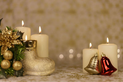 Close-up of christmas decorations with candles on table