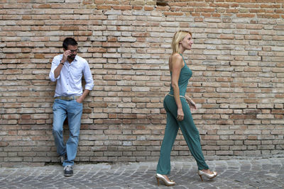 Man standing in a street and looking at a woman