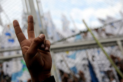 Close-up of man hand against built structure