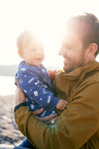 Father embracing daughter outdoors