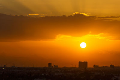 Scenic view of buildings against sky during sunset