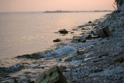 Summer evening, sunset. .scenery. river, tide, waves. rocky shore.