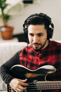 Portrait of man playing guitar