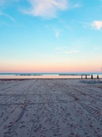 Scenic view of beach against sky during sunset