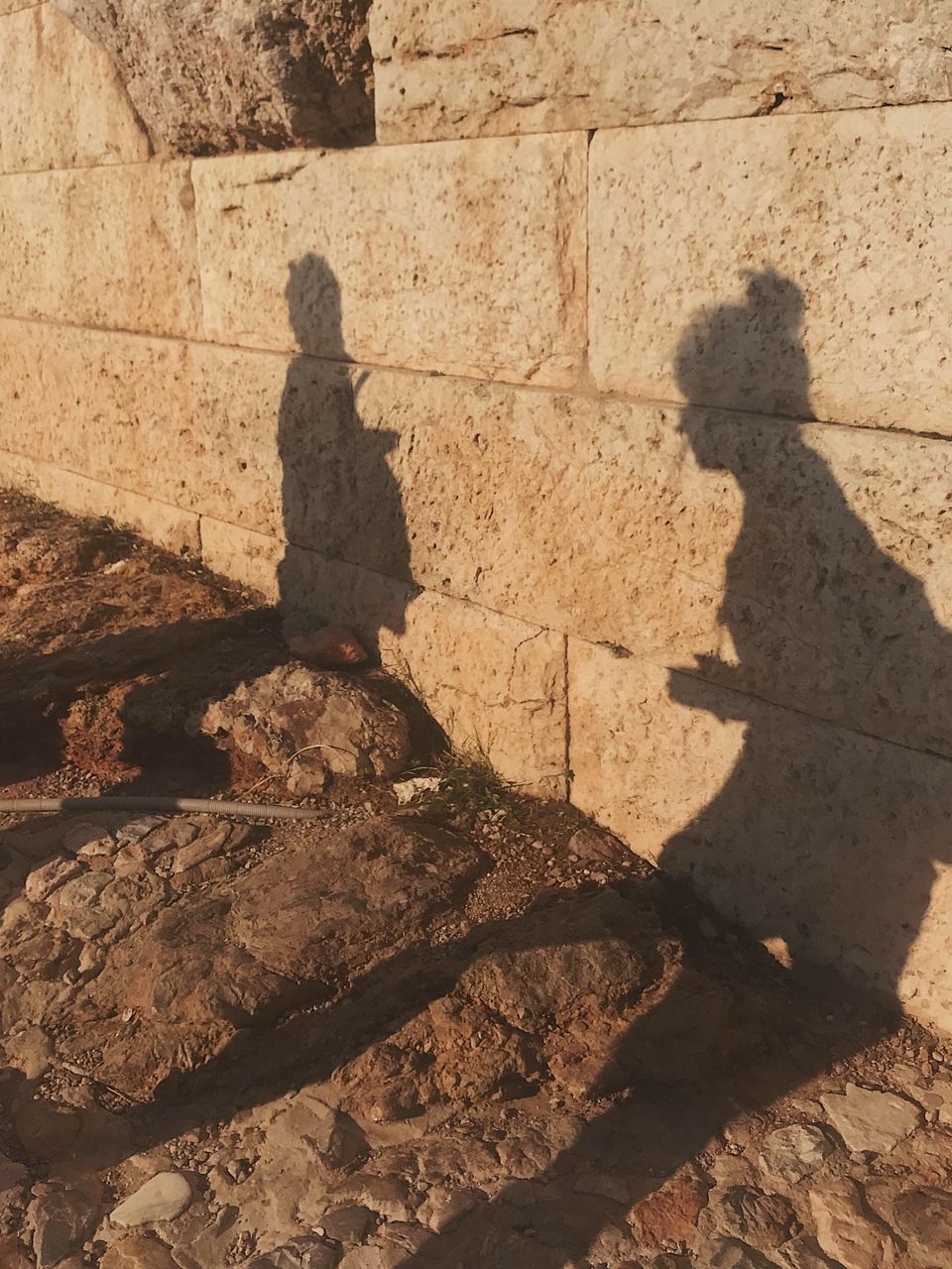 SHADOW OF PEOPLE ON ROCKS