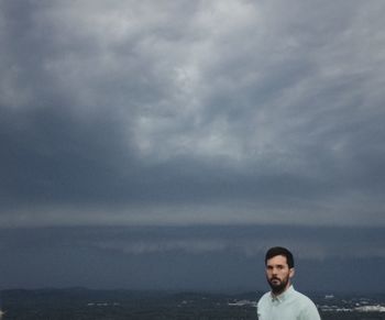 Silhouette of woman against cloudy sky