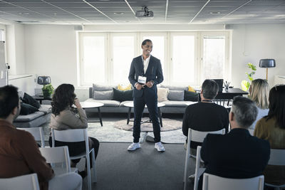 Group of business people attending presentation during conference