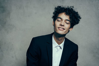 Portrait of young man against wall