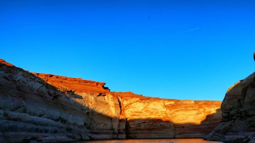 View of rock formations against blue sky