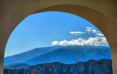 Low angle view of mountains against blue sky