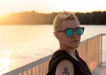 Portrait of man wearing sunglasses against sky during sunset