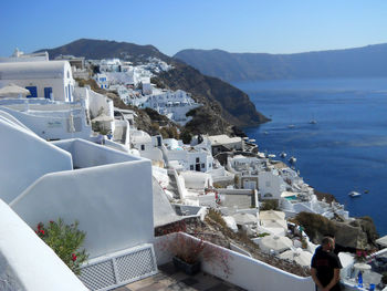 High angle view of townscape by sea against sky