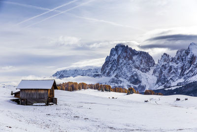 Scenic view of snow covered field against mountains