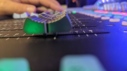 Cropped hand of man using sound mixer