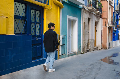 Young transgender walking outdoors on the street.