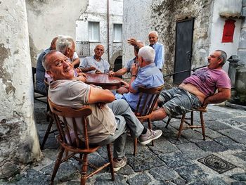 People sitting outside building