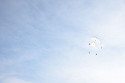 Low angle view of kite flying against sky