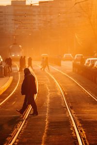 Man walking on railroad tracks at night