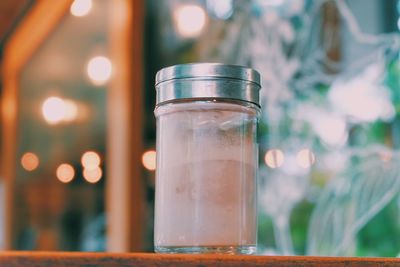 Close-up of drink in jar on wooden table