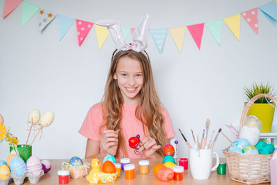 Portrait of smiling woman with colorful balloons