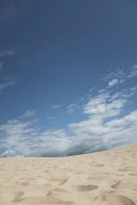 Scenic view of desert against blue sky