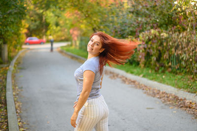 Portrait of woman standing on road