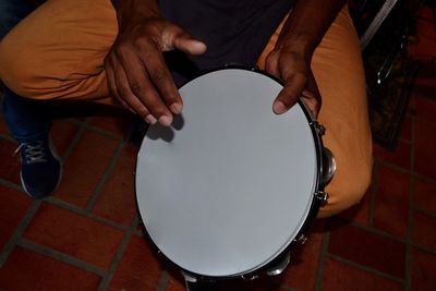 Low section of man sitting on tiled floor