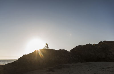 France, crozon peninsula, mountainbiker at sunset