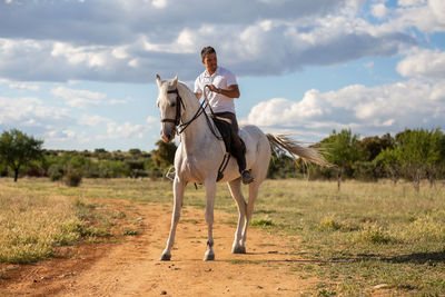 Man riding horse on field