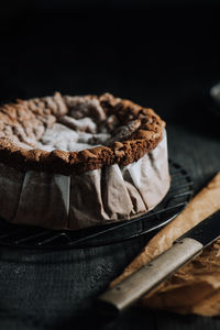 Close-up of cake in container against black background