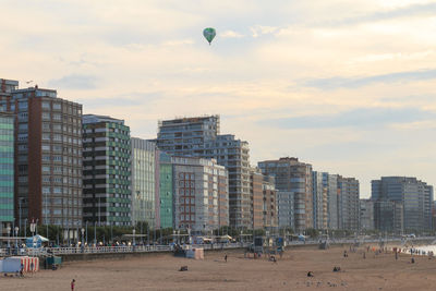 Buildings in city against sky during sunset