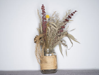 Close-up of vase on table against white background