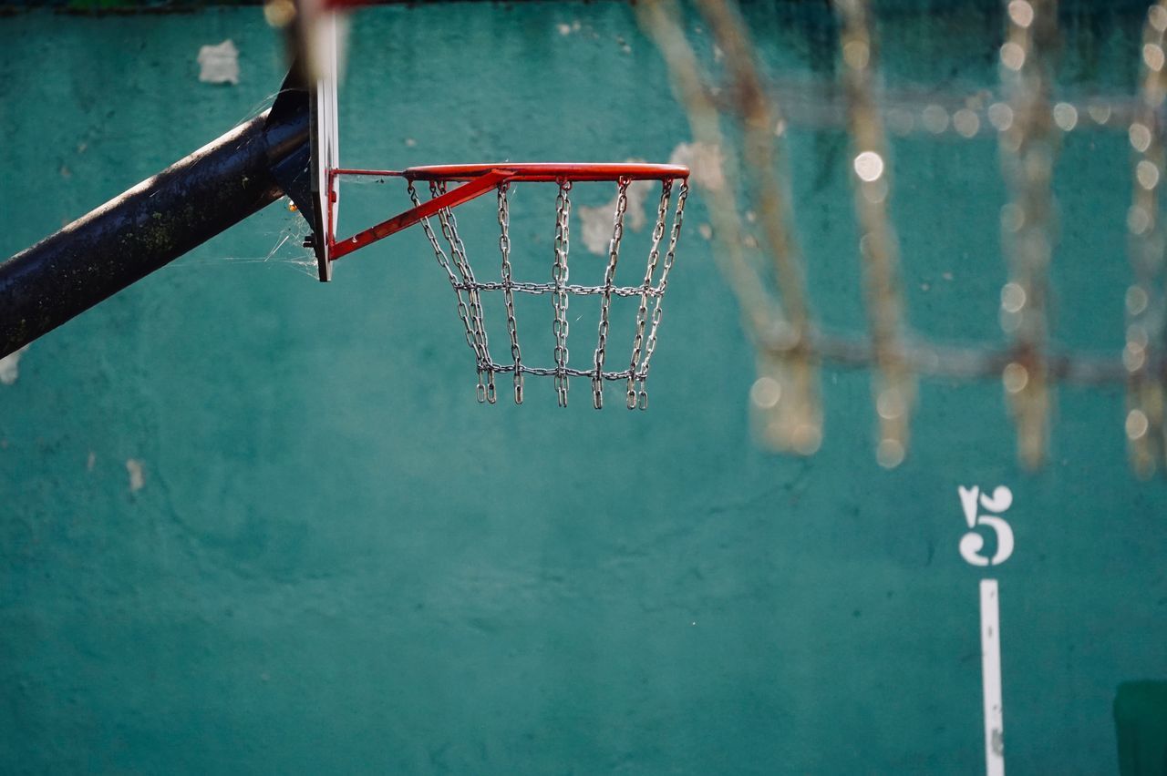CLOSE-UP OF BASKETBALL HOOP ON SNOWY LANDSCAPE