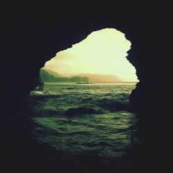 Scenic view of sea seen through cave