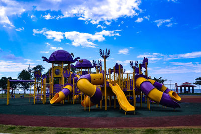 View of playground against blue sky