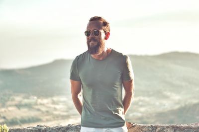 Full length of man standing on mountain against sea