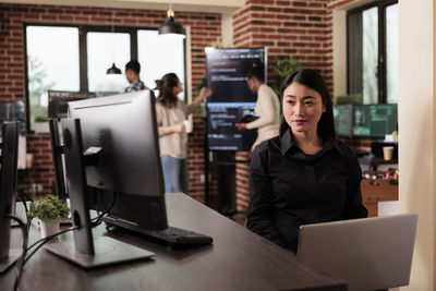 Young woman using laptop at office