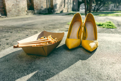 Close-up of yellow shoes on floor