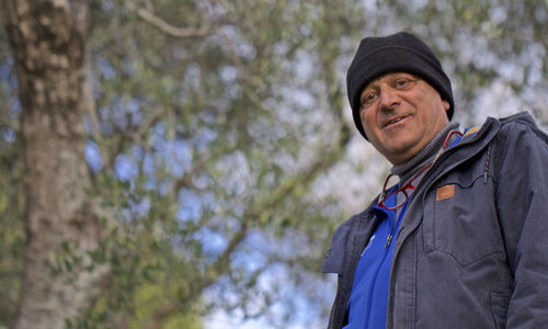 Portrait of man standing against plants