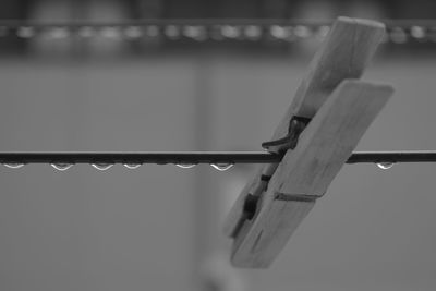 Close-up of clothespins hanging on water