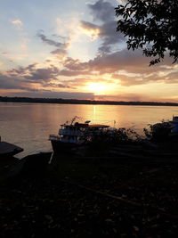 Boat in sea at sunset