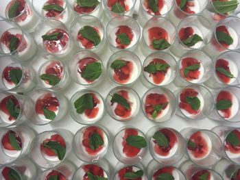 Directly above shot of basil panna cotta with strawberry in glass