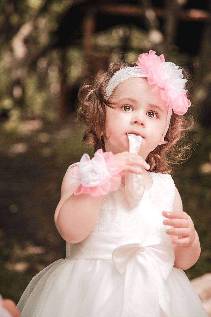 childhood, elementary age, girls, cute, innocence, pink color, person, front view, selective focus, focus on foreground, holding, nature, casual clothing, make-up, human face, day, flower, young adult, cherry blossom